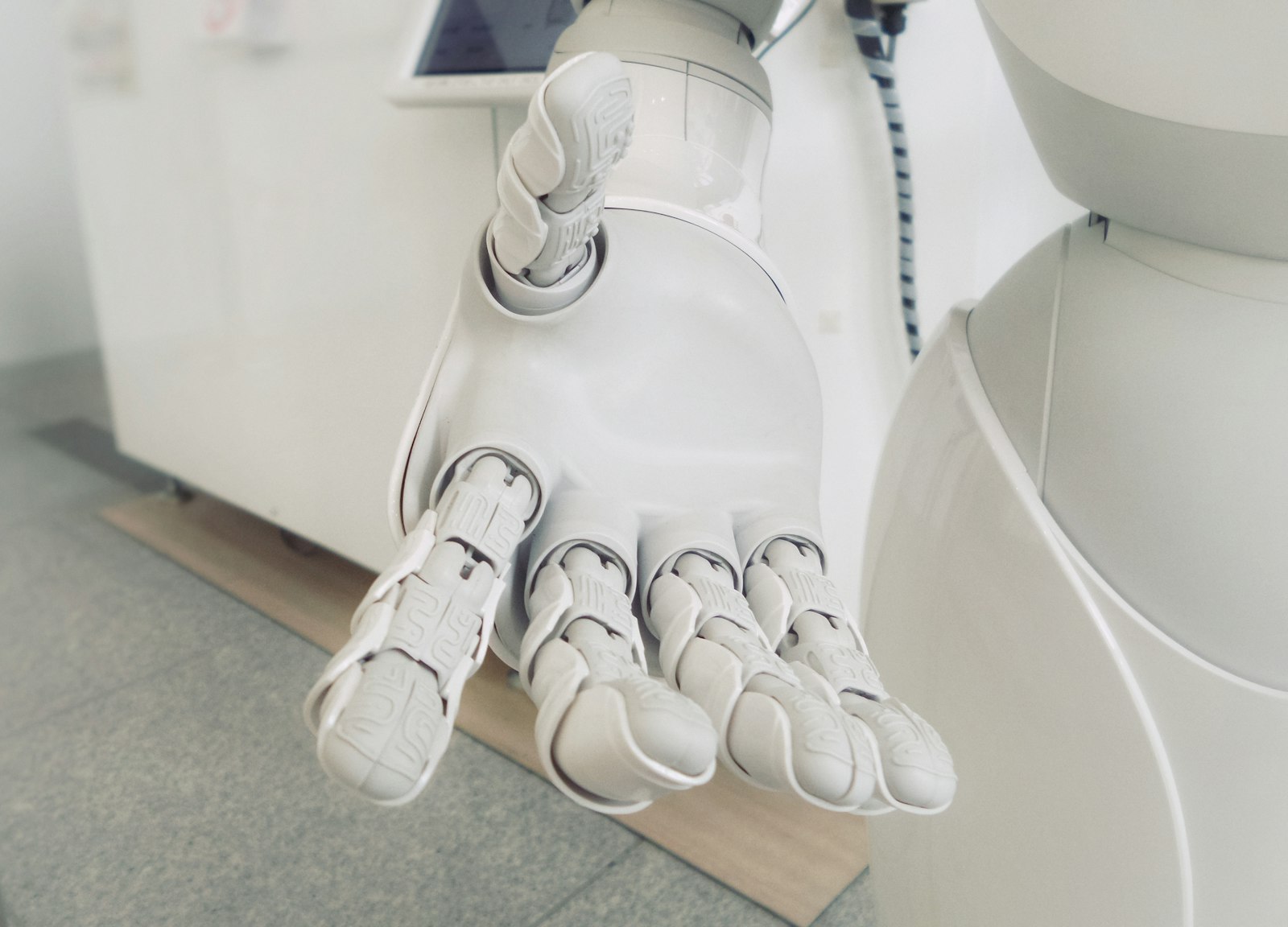 A white robotic hand reaching outward