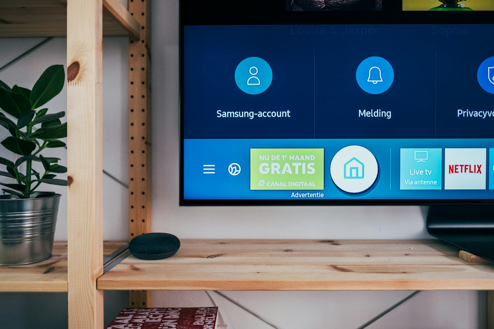 A wall-mounted digital display showing an on-screen content menu